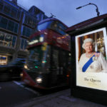 
              A picture of Queen Elizabeth sits on a bus stop in London, Friday, Sept. 9, 2022. Queen Elizabeth II, Britain's longest-reigning monarch and a rock of stability across much of a turbulent century, died Thursday Sept. 8, 2022, after 70 years on the throne. She was 96. (AP Photo/Kirsty Wigglesworth)
            