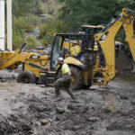 
              Workers with the Yucaipa Valley Water District work on repairing a reservoir used as a drinking source in the aftermath of a mudslide, Tuesday, Sept. 13, 2022, in Oak Glen, Calif. (AP Photo/Marcio Jose Sanchez)
            