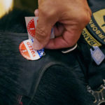 
              New Hampshire Republican U.S. Senate candidate Don Bolduc places a "I Voted Today" sticker on the harness of his dog "Victor" after casting his vote, Tuesday, Sept. 13, 2022, in Stratham, N.H. (AP Photo/Charles Krupa)
            