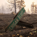 
              A burnt out road sign is seen near Michigan Bluff during the Mosquito Fire in unincorporated Placer County, Calif. Thursday, Sept. 8, 2022. (Stephen Lam/San Francisco Chronicle via AP)
            