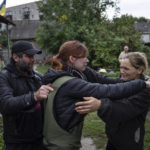 
              Maria, center, hugs her parents Marina and Alexander during their first meeting after seven months since the beginning of the war in the recently retaken town of Izium, Ukraine, Wednesday, Sept. 14, 2022. (AP Photo/Evgeniy Maloletka)
            