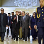 
              In this handout photo released by Pakistan Prime Minister Office, U.N. Secretary-General Antonio Guterres, center, walk with Pakistan Prime Minister Shahbaz Sharif as they chat with each others at the Prime Ministry office in Islamabad, Pakistan, Friday, Sept. 9, 2022. Guterres appealed to the world to help Pakistan after arriving in the country Friday to see climate-induced devastation from months of deadly record floods that have left half a million people living in tents under the open sky.(Pakistan Prime Minister Office via AP)
            