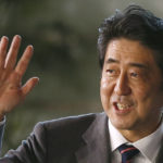 
              FILE - Japan's newly-named Prime Minister Shinzo Abe waves at the media upon his arrival at the prime minister's official residence following his election at Parliament in Tokyo on Dec. 26, 2012. Japan is filled with tension, rather than sadness, on Tuesday, Sept. 27, 2022 as a rare state funeral for the assassinated former Prime Minister Abe, one of the most divisive leader, deeply splits the nation. (AP Photo/Shizuo Kambayashi, File)
            