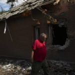 
              The head of the rapid response unit Taras Logginov walks in front of the damaged building of the Ukrainian Red Cross Society that was hit last week during a Russian attack in Sloviansk, Ukraine, Monday, Sept. 5, 2022. (AP Photo/Leo Correa)
            