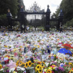 
              Floral tributes are placed at Norwich Gates by members of the public, in memory of late Queen Elizabeth II, at the Sandringham Estate, in Norfolk, England, Thursday, Sept. 15, 2022. (Toby Melville/Pool via AP)
            