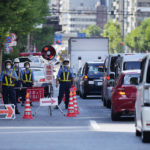 
              Police officers maintain a checkpoint as authorities have deployed extra officers to beef up security for the state funeral of former Prime Minister Shinzo Abe in Tokyo, Monday, Sept. 26, 2022. Japanese Prime Minister Fumio Kishida is hosting the controversial state-sponsored ceremony for the former leader Tuesday. (AP Photo/Hiro Komae)
            