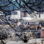 
              A vehicle rests amid homes leveled by the Mill Fire in Weed, Calif., on Saturday, Sept. 3, 2022. (AP Photo/Noah Berger)
            