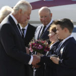 
              King Charles III is greeted by Ella Smith aged 10, and Lucas Watt aged 10 as he arrives at Belfast City Airport as the King continues his tour of the four home nations in Northern Ireland, Tuesday Sept. 13, 2022. Charles and Camilla are visiting the four home nations of the UK in the run-up to the state funeral for Queen Elizabeth II on Monday. (Liam McBurney/pool via AP)
            