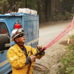 
              Pacific Gas & Electric firefighter Dave Ronco sprays retardant on a utility pole to protect infrastructure as the Mosquito Fire burns near Volcanoville in El Dorado County, Calif., on Friday, Sept. 9, 2022. (AP Photo/Noah Berger)
            