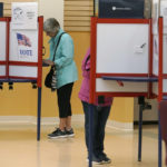 
              Voters fills out ballots, Tuesday, Sept. 6, 2022, in the Massachusetts primary election at a polling place, in Attleboro, Mass. (AP Photo/Steven Senne)
            