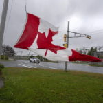 
              A Canadian flag waves in the high winds in Dartmouth, N.S. on Saturday, Sept. 24, 2022.   Strong rains and winds lashed the Atlantic Canada region as Fiona closed in early Saturday as a big, powerful post-tropical cyclone, and Canadian forecasters warned it could be one of the most severe storms in the country's history.  (Andrew Vaughan /The Canadian Press via AP)
            