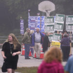 
              Voters walk past campaign volunteers at a polling place, Tuesday, Sept. 13, 2022, in Stratham, N.H. (AP Photo/Charles Krupa)
            
