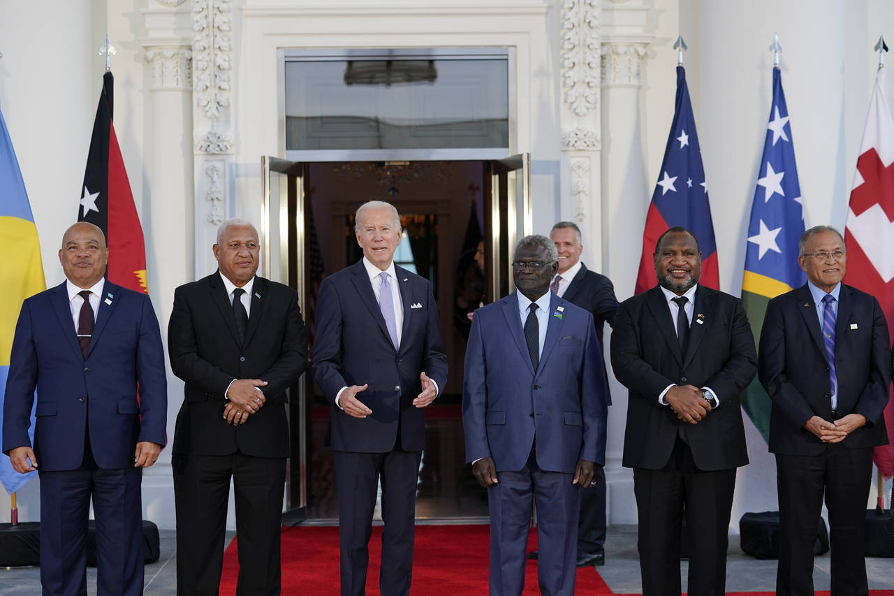 President Joe Biden, third from left, speaks as he poses for photos with Pacific Island leaders on ...