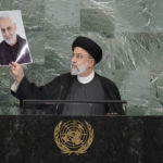 
              President of Iran Ebrahim Raisi holds up a photo of slain Iranian Gen. Qassem Soleimani, as he addresses the 77th session of the United Nations General Assembly, Wednesday, Sept. 21, 2022 at U.N. headquarters. (AP Photo/Mary Altaffer)
            