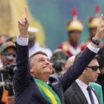
              Brazil's President Jair Bolsonaro points up during a military parade to celebrate the bicentennial of the country's independence from Portugal, in Brasília, Brazil, Wednesday, Sept. 7, 2022. (AP Photo/Eraldo Peres)
            