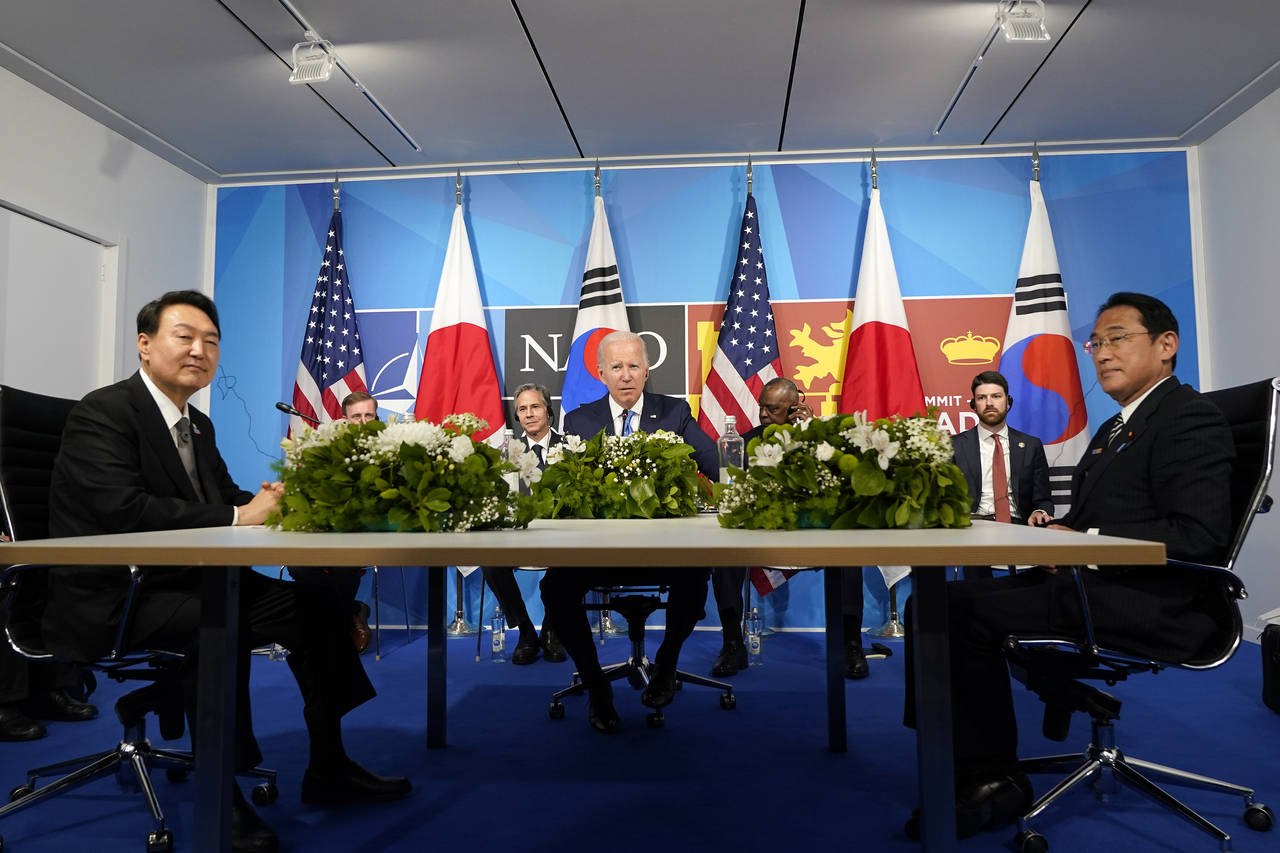FILE - President Joe Biden, center, meets with South Korea's President Yoon Suk Yeol, left, and Jap...
