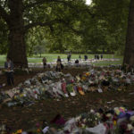 
              People place flowers for Queen Elizabeth II at Green Park, near Buckingham Palace in London, Sept. 10, 2022. (AP Photo/Felipe Dana)
            