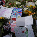 
              Children's drawings and a note from a nursery school to pay their respects to Queen Elizabeth II in front of the gates of Windsor Castle in Windsor, England, Friday, Sept. 9, 2022. Queen Elizabeth II, Britain's longest-reigning monarch and a rock of stability across much of a turbulent century, died Thursday after 70 years on the throne. She was 96. (AP Photo/Frank Augstein)
            