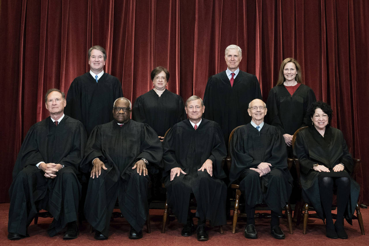 FILE - Members of the Supreme Court pose for a group photo at the Supreme Court in Washington, Apri...