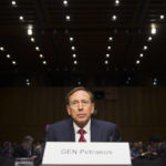 
              FILE - Former CIA Director David Petraeus prepares to testify on Capitol Hill in Washington, Sept. 22, 2015, before the Senate Armed Services Committee hearing on Middle East policy. Petraeus apologized to Congress for sharing classified information with a biographer with whom he was having an affair. Petraeus, was forced to resign and pleaded guilty to a federal misdemeanor for sharing classified material. (AP Photo/Evan Vucci, File)
            