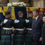 
              CAPTION CORRECTS BYLINE Vice Admiral Timothy Laurence and Princess Anne stand solemnly as the coffin of Queen Elizabeth II, draped with the Royal Standard of Scotland, as it arrives at Holyroodhouse, Edinburgh, where it will lie in rest for a day, Sunday Sept. 11, 2022. (Aaron Chown/Pool Photo via AP)
            