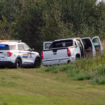 
              Police and investigators are seen at the side of the road outside Rosthern, Saskatchewan on Wednesday, Sept. 7, 2022. Canadian police arrested the second suspect in the stabbing deaths of 10 people in the province of Saskatchewan on Wednesday after a three-day manhunt during which they had found the body of his brother. (Kelly Geraldine Malone/The Canadian Press via AP)
            