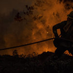 
              A firefighter with the Cal Fire Santa Clara Unit drags a hose while battling the Mosquito Fire near Michigan Bluff in unincorporated Placer County, Calif. Wednesday, Sept. 7, 2022. (Stephen Lam/San Francisco Chronicle via AP)
            