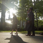 
              FILE - Graduates walk at a Harvard Commencement ceremony held for the classes of 2020 and 2021, Sunday, May 29, 2022, in Cambridge, Mass. The Department of Education says borrowers who hold eligible federal student loans and have made voluntary payments since March 13, 2020, can get a refund. (AP Photo/Mary Schwalm)
            