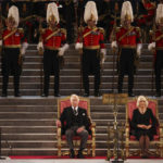 
              King Charles III and Camilla, the Queen Consort sit, in Westminster Hall, where both Houses of Parliament met to express their condolences, following the death of Queen Elizabeth II, in London, Monday, Sept. 12, 2022. Queen Elizabeth II, Britain's longest-reigning monarch and a rock of stability across much of a turbulent century, died Thursday Sept. 8, 2022, after 70 years on the throne. She was 96. (Dan Kitwood/Pool Photo via AP)
            