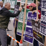 
              New Hampshire Republican U.S. Senate candidate Don Bolduc, shakes hands with campaign volunteers after voting, Tuesday, Sept. 13, 2022, in Stratham, N.H. (AP Photo/Charles Krupa)
            