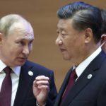 
              Russian President Vladimir Putin, left, gestures while speaking to Chinese President Xi Jinping during the Shanghai Cooperation Organization (SCO) summit in Samarkand, Uzbekistan, Friday, Sept. 16, 2022. (Sergei Bobylev, Sputnik, Kremlin Pool Photo via AP)
            