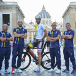 
              In this undated photo made available by Athletica Vaticana on Thursday, Sept. 22, 2022, Dutch-born cyclist Rien Schuurhuis, center, poses with his team in front of St. Peter's Basilica at The Vatican. Schuurhuis will race for the Vatican in the Sunday, Sept. 25, 2022 road race at the cycling world championships in Wollongong, Australia. It's the first time that the Vatican has entered a team for the event. Chiara Porro, Schuurhuis' wife, is Australia's ambassador to the Holy See. (Ivan Sommonte/Athletica Vaticana)
            