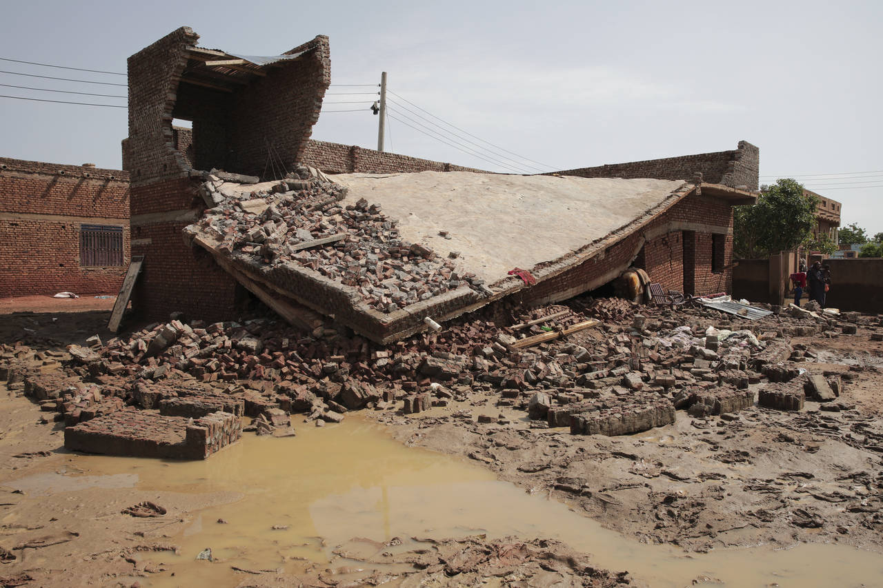 FILE - Damage is seen after a heavy rainfall in the village of Aboud in the El-Manaqil district of ...