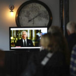 
              Members of the public watching a broadcast of King Charles III first address to the nation as the new King following the death of Queen Elizabeth II, in The Prince Harry Pub, Windsor, England, Friday, Sept. 9, 2022. (John Walton/PA via AP)
            