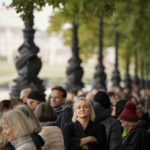 
              People queue opposite the Palace of Westminster to be first in line bidding farewell to Queen Elizabeth II in London, Wednesday, Sept. 14, 2022. Queen Elizabeth II, Britain's longest-reigning monarch and a rock of stability across much of a turbulent century, died Thursday Sept. 8, 2022, after 70 years on the throne, at the age of 96. (AP Photo/Andreea Alexandru)
            