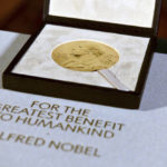 
              FILE - The Nobel diploma and medal in physiology or medicine presented to Charles M. Rice is displayed, Tuesday, Dec. 8, 2020, during a ceremony in New York.  This year’s Nobel season approaches as Russia’s invasion of Ukraine has shattered decades of almost uninterrupted peace in Europe and raised the risks of a nuclear disaster. The famously secretive Nobel Committee never leaks or hints who will win its prizes for medicine, physics, chemistry, literature, economics or peace. So it is anyone’s guess who might win the awards that will be announced starting next Monday, Oct. 3, 2022. (Angela Weiss/Pool Photo via AP, File)
            