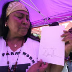 
              Farmworker Xochilt Nunez, holds a copy of the bill signed by Gov. Gavin Newsom aimed at making it easier for farmworkers to unionize, in Sacramento, Calif., Wednesday, Sept. 28, 2022. Farmworkers had been camped outside the Capitol for a month calling on the Newsom to sign the bill. (AP Photo/Rich Pedroncelli)
            
