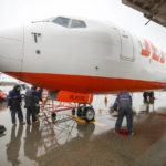 
              Jeju Air's mechanics tie up a plane on the tarmac as Typhoon Hinnamnor moves toward the Korean Peninsula at Gimpo International Airport in Seoul, South Korea, Monday, Sept. 5, 2022. Hundreds of flights were grounded and more than 200 people evacuated in South Korea on Monday as Typhoon Hinnamnor approached the country's southern region with heavy rains and winds of up to 290 kilometers (180 miles) per hour, the strongest storm in decades. (Korea Pool/Yonhap via AP)
            