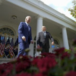 
              President Joe Biden, left, and Bob Parant, a Medicare beneficiary, walk out to speak in the Rose Garden of the White House in Washington, Tuesday, Sept. 27, 2022, during an event on health care costs. (AP Photo/Susan Walsh)
            