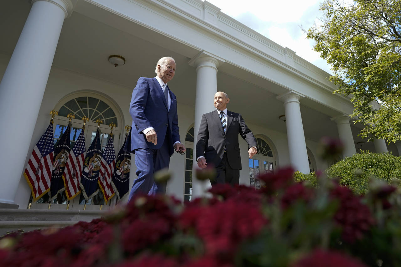 President Joe Biden, left, and Bob Parant, a Medicare beneficiary, walk out to speak in the Rose Ga...