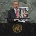 
              President of Turkey Recep Tayyip Erdogan hold up a photo of Syrian refugee children addresses the 77th session of the United Nations General Assembly, Tuesday, Sept. 20, 2022 at U.N. headquarters. (AP Photo/Mary Altaffer)
            