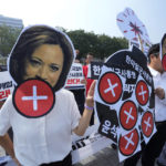 
              Protesters, two of them wearing masks of U.S. Vice President Kamala Harris and South Korean President Yoon Suk Yeol, join a rally to oppose a visit by Harris, in front of the presidential office in Seoul, South Korea, Thursday, Sept. 29, 2022. (AP Photo/Ahn Young-joon)
            