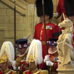 
              The King's Body Guard, formed of Gentlemen at Arms, Yeomen of the Guard and Scots Guards, wait to change guard duties around the coffin of Queen Elizabeth II, Lying in State inside Westminster Hall, at the Palace of Westminster, in London, Sunday, Sept. 18, 2022, ahead of her funeral on Monday. (AP Photo/Vadim Ghirda, pool)
            