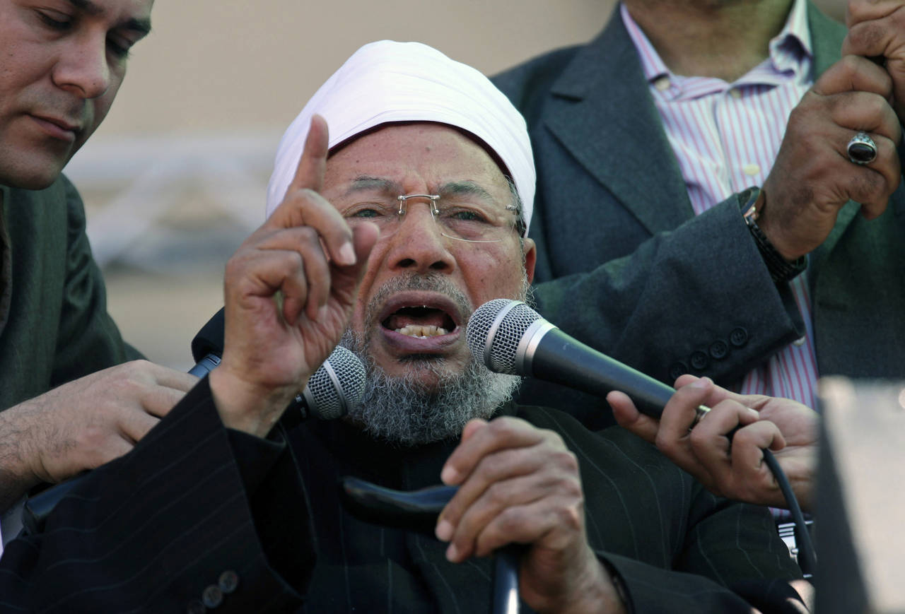 FILE -Senior Egyptian cleric Sheik Youssef al-Qardawi speaks to the crowd as he leads Friday prayer...