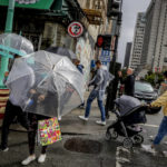 
              Rain drenches streets in Chinatown in San Francisco, on Sunday, Sept. 18, 2022. The rainstorm is a dramatic shift of events for many residents after a record heat wave and grueling wildfire season. (Brontë Wittpenn/San Francisco Chronicle via AP)
            