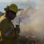 
              A firefighters watches as a wildfire burns in Castaic, Calif. on Wednesday, Aug. 31, 2022. (AP Photo/Ringo H.W. Chiu)
            