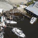 
              Damages boats lie on the land and water in the aftermath of Hurricane Ian, Thursday, Sept. 29, 2022, in Fort Myers, Fla. (AP Photo/Wilfredo Lee)
            