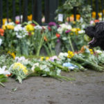 
              A dog stands by flowers laid outside Windsor Castle for late Queen Elizabeth II in Windsor, England, Thursday, Sept. 15, 2022. The Queen will lie in state in Westminster Hall for four full days before her funeral on Monday Sept. 19. (AP Photo/Gregorio Borgia)
            