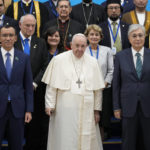 
              Pope Francis, center, poses with Kazakhstan's President Kassym-Jomart Tokayev, right front row, and religious leaders for a family photo at the '7th Congress of Leaders of World and Traditional Religions, in Nur-Sultan, Kazakhstan, Wednesday, Sep. 14, 2022. Against the backdrop of Russia's invasion of Ukraine, Francis opened an interfaith conference in the former Soviet republic of Kazakhstan by challenging delegations to unite in condemning war. (AP Photo/Andrew Medichini)
            