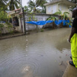 
              A worker of the Loiza municipality calls on residents to evacuate due to imminent flooding due to the rains of Hurricane Fiona, in Loiza, Puerto Rico, Sunday, September 18, 2022. (AP Photo/Alejandro Granadillo)
            